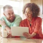 man and woman looking at a computer.